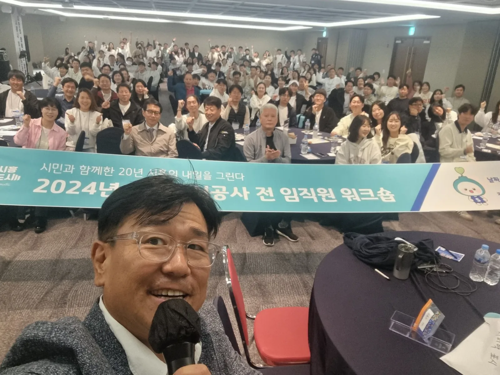 워크숍 현장에서 마이크를 잡고 진행하는 MC 신용주